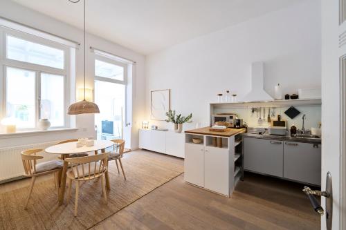 a kitchen and dining room with a table and chairs at Ferien Domizil 25 in Norderney