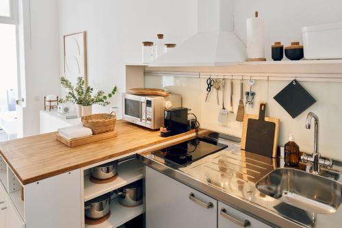 a kitchen with a counter top with a microwave at Ferien Domizil 25 in Norderney