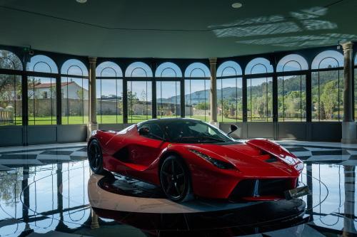a red car on a table in a room with windows at Maison Albar - Amoure in Braga