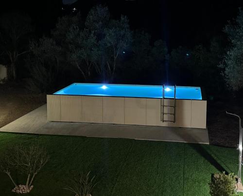 a swimming pool at night with lights on it at Villa with Private Pool near the Beach and Pula in Sarroch