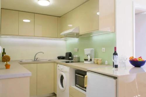 a kitchen with a washing machine and a dishwasher at Bellevue Suites in Agios Nikolaos