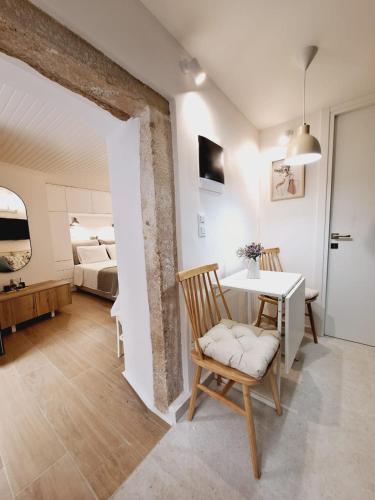 a room with a table and chairs and a bedroom at Casa Myrilla in Corfu
