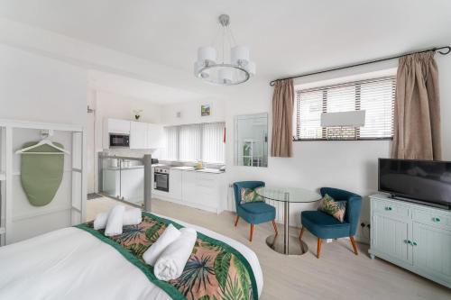 a bedroom with a bed and a table and chairs at 2 The Stables in Bowness-on-Windermere