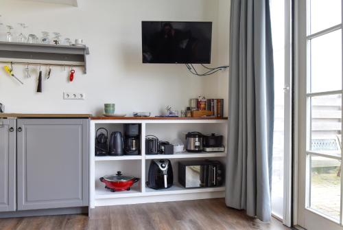 une cuisine avec une étagère blanche dans l'établissement Pronkhuisje, à Oterleek