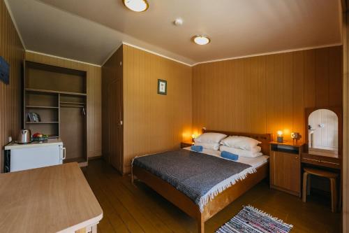 a bedroom with a bed and a table in it at Kastytis in Nida