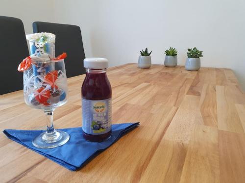 a bottle of beer next to a glass on a table at L'Arco Trieste studio living 1 in Trieste