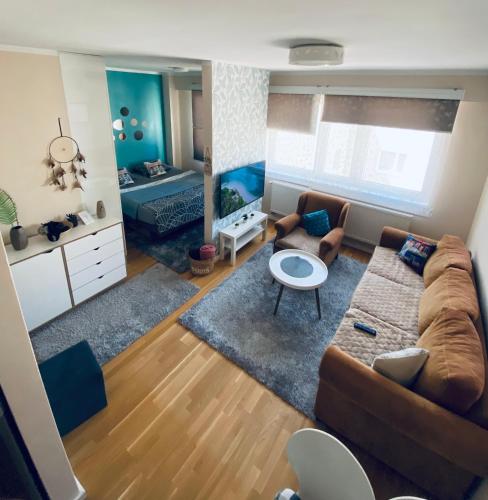 a living room with a couch and a table at Apartman Otoka-Meandar in Sarajevo