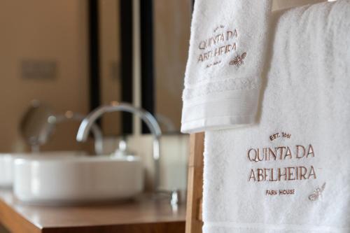 a towel on a bathroom counter next to a sink at Quinta da Abelheira 1660 in Sobral da Abelheira