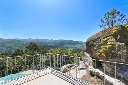a balcony with a view of a rock at Casas das Olas in Arcos de Valdevez