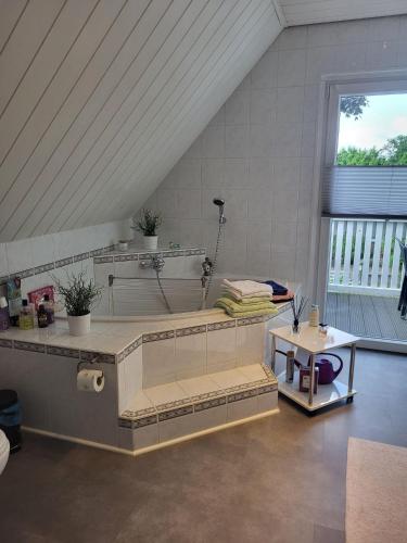 a large bathroom with a tub and a table at Ferienwohnung am Allerbogen in Neu Wietze