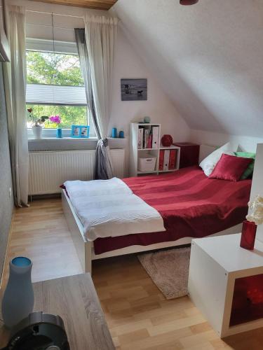 a bedroom with a large bed and a window at Ferienwohnung am Allerbogen in Neu Wietze