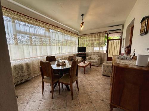 a living room with a table and chairs and a couch at Georgaras Accommodation in Platanoússa