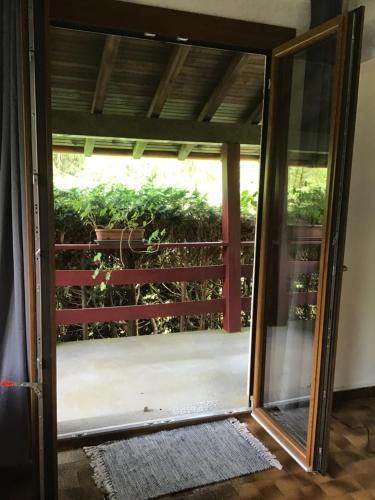 an open door to a balcony with a plant at Au p’tit paradis in Fresse