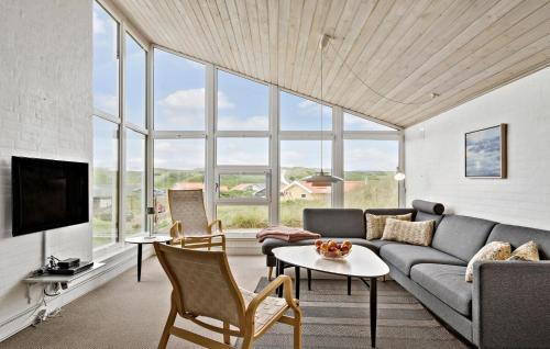 a living room with a couch and a table at Four-Bedroom Holiday Home In Hvide Sande in Bjerregård