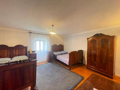 a bedroom with two beds and wooden furniture at Apartment Kalikut in Beli