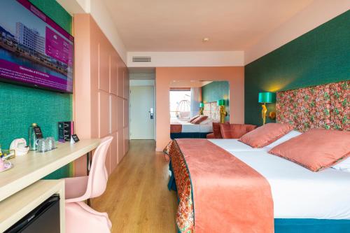 a hotel room with a bed and a desk at NYX Hotel Ibiza by Leonardo Hotels-Adults Only in San Antonio Bay