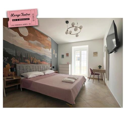 a bedroom with a large bed with a painting on the wall at Largo Teatro Bed & Breakfast in Bitonto