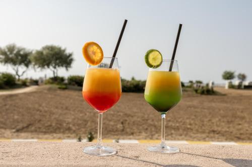 two glasses of different colored drinks sitting on a table at Hotel Monaco in Caorle