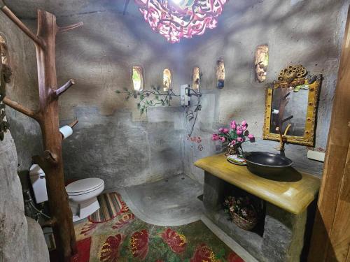 a bathroom with a sink and a toilet in a room at Clay House Chiang Mai By Alphatel in Chiang Mai
