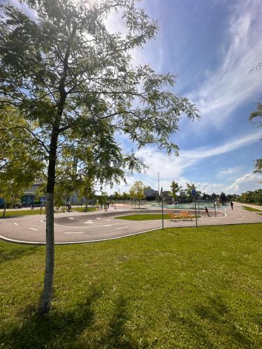 a tree in the grass in a park at AMAO Obsidian - 120 m2 Business & Family Apartment - 3 Bedrooms - 8 Guests - King-Size Beds in Schwanau
