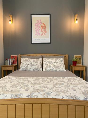 a bed in a bedroom with two end tables at Casa Akrolithos in Keramoti