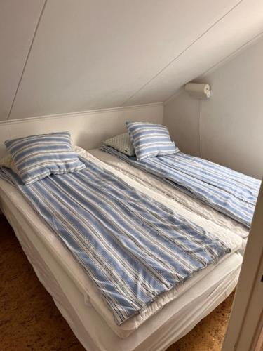 a bed with two pillows on it in a room at Vandrarhem Varvet in Ellös
