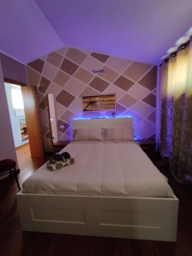 a bedroom with a large bed with purple lighting at Appartamento Silvana Terme in Rapolano Terme