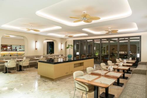 a restaurant with tables and chairs and a ceiling at Arts Hotel Bodrum Yalikavak in Yalıkavak