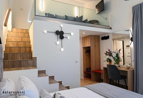a bedroom with a staircase and a clock on the wall at Asteroskoni Luxury Suites in Nafplio
