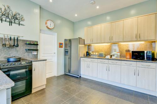 a kitchen with white cabinets and a stainless steel refrigerator at The Old Laundry, Exford in Exford