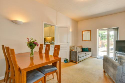 a dining room with a table and a couch at The Old Laundry, Exford in Exford