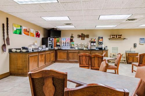 a restaurant with a counter and a table and chairs at Quality Inn & Suites in Carthage