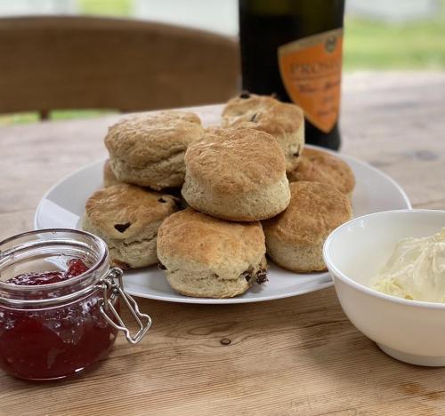 a plate of biscuits and a jar of jam on a table at The Piggery, Dulverton in Dulverton