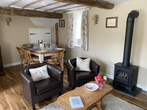 a living room with a stove and a table at The Piggery, Dulverton in Dulverton