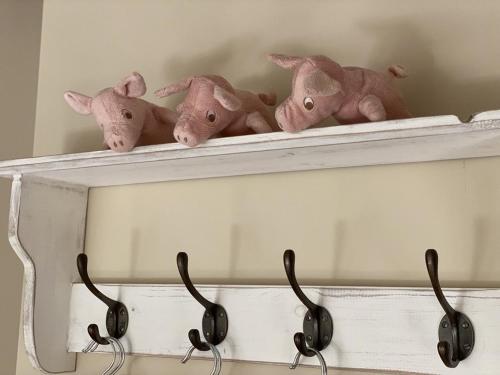 a shelf with four stuffed animals on it at The Piggery, Dulverton in Dulverton