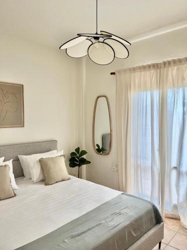 a bedroom with a large bed and a window at The Yard Residence in Gavalochori