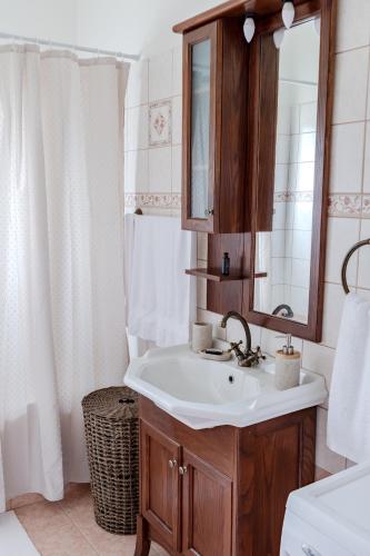 a bathroom with a sink and a mirror at The Yard Residence in Gavalochori