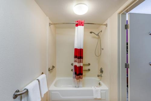 a bathroom with a white tub and a shower at Red Roof Inn Kalamazoo East – Expo Center in Kalamazoo