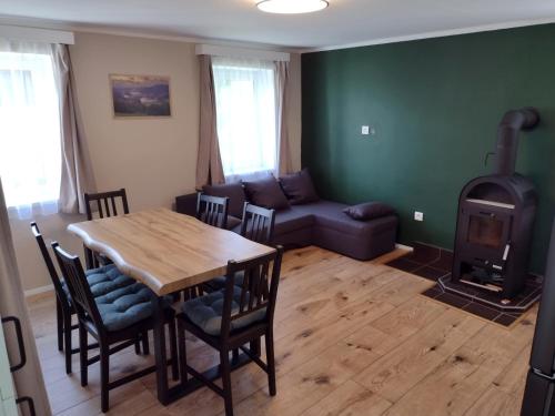 a living room with a table and a wood stove at Chata Nad rybníkem Hnačov in Hnačov