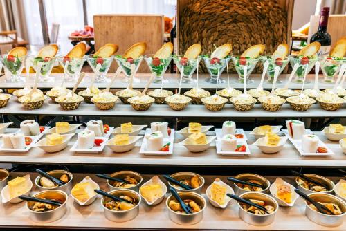 a buffet line with many different types of food at Vincci Resort Costa Golf in Chiclana de la Frontera