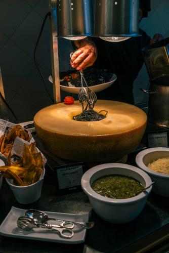a person is making food in a bowl on a table at Vincci Resort Costa Golf in Chiclana de la Frontera