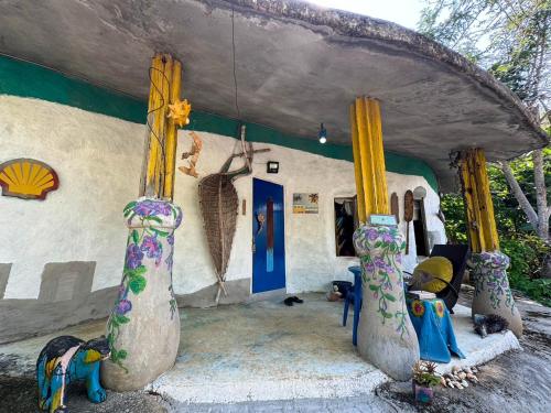 a room with four statues in front of a house at Clay House Chiang Mai By Alphatel in Chiang Mai