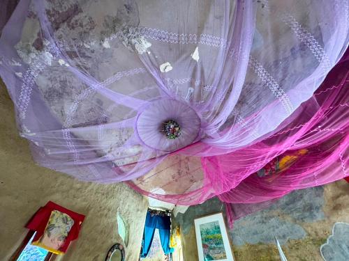 a purple curtain hanging from a ceiling at Clay House Chiang Mai By Alphatel in Chiang Mai