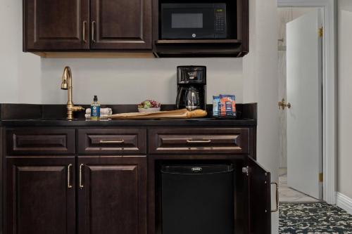 a kitchen with a sink and a microwave at Inn at the Opera in San Francisco