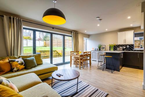 a living room with a couch and a table at Modern home - great facilities-J26 M1 near IKEA in Nottingham