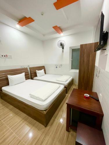 Postel nebo postele na pokoji v ubytování Khách sạn Mỹ Uyên