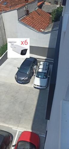 two cars parked in a parking lot next to a building at Lux apartment 10 center, free parking in Niš