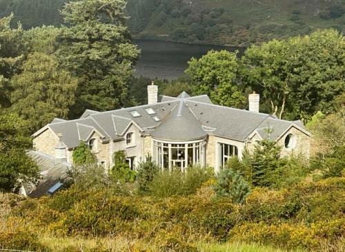 a large house on top of a hill at LD1000 ,Lough Dan in Carraigeenshinna