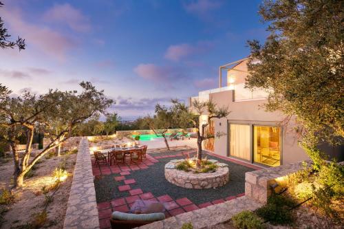 a house with a patio and a swimming pool at LILY'S VILLA LEMONIA in Platanes
