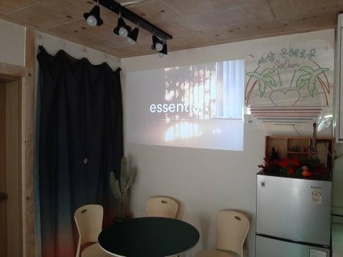 a dining room with a table and a refrigerator at Seeun house in Gwangju